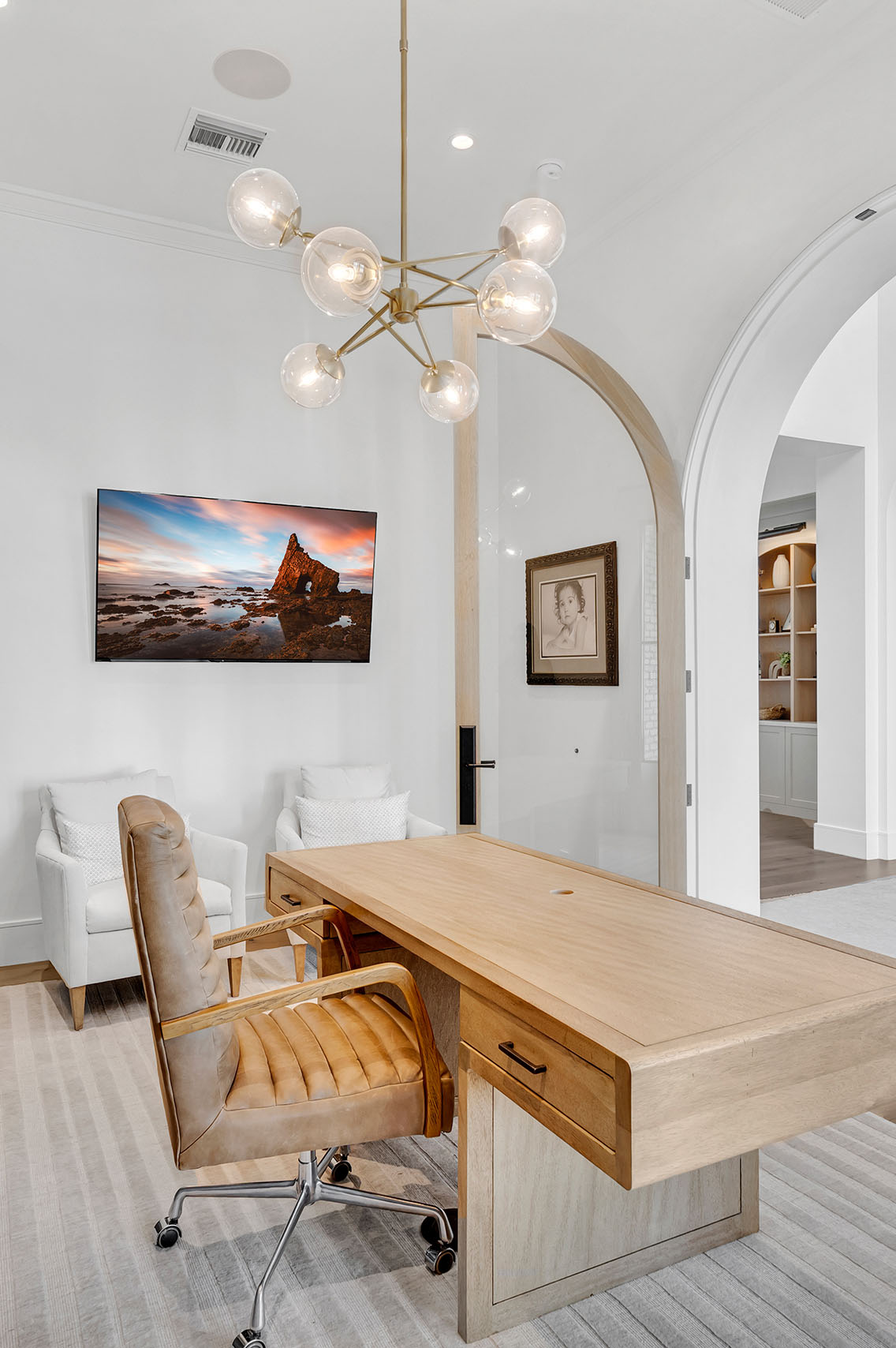Elegant Home Office with Arched Glass Doors – A stylish home office featuring arched glass double doors with natural wood frames, dark built-in cabinetry, and modern decor for a sophisticated workspace.