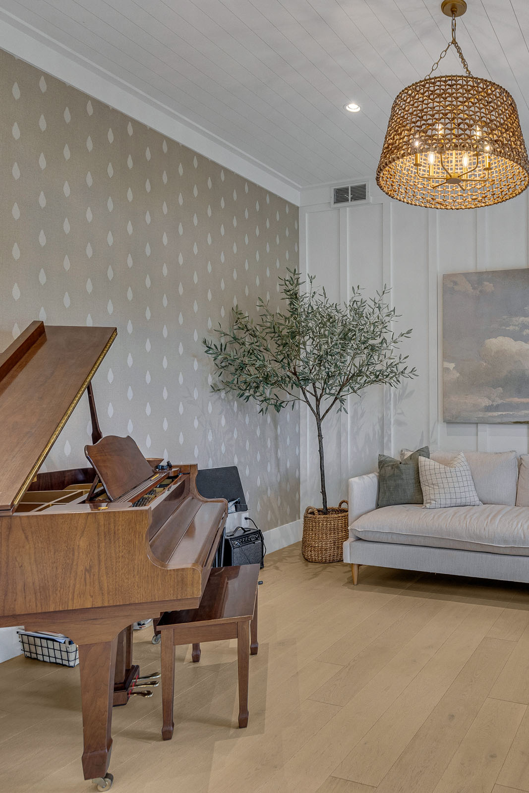 Charming Music Room with Grand Piano – A refined music room with a grand piano, board-and-batten walls, and a woven chandelier, designed to enhance acoustics and ambiance in a luxury home.