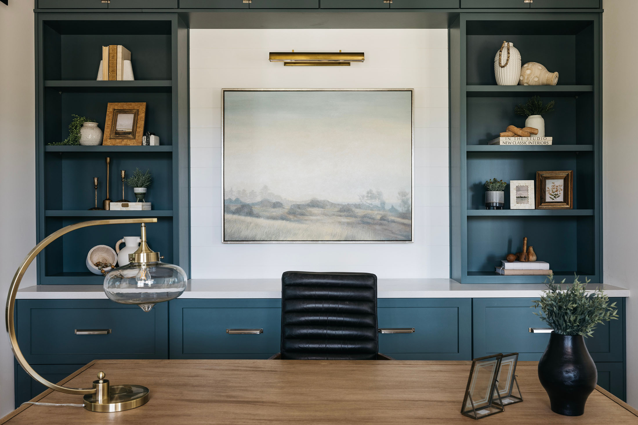 Sophisticated Home Office with Custom Built-Ins – Luxury home office featuring deep green custom built-in cabinetry, warm wood desk, and brass accents, creating an elegant workspace with timeless design.