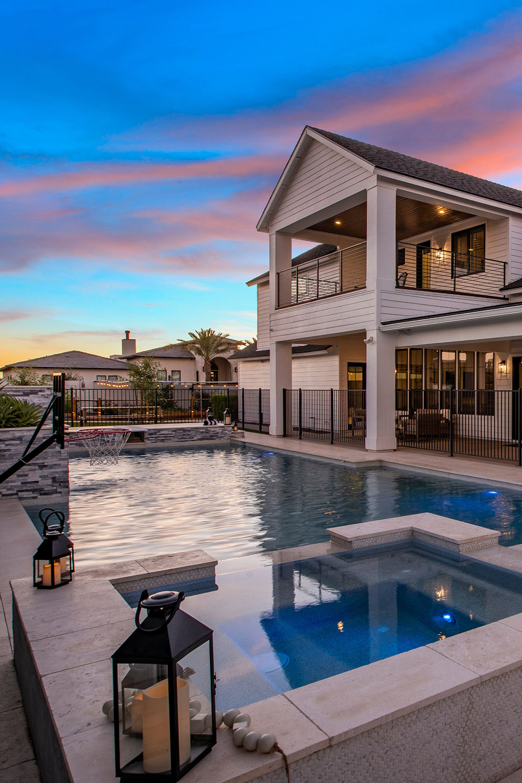 Modern two-story home with backyard pool and balcony – A beautifully designed two-story home with a spacious backyard, featuring a luxurious pool, a spa, and an elegant upper balcony with modern railings.