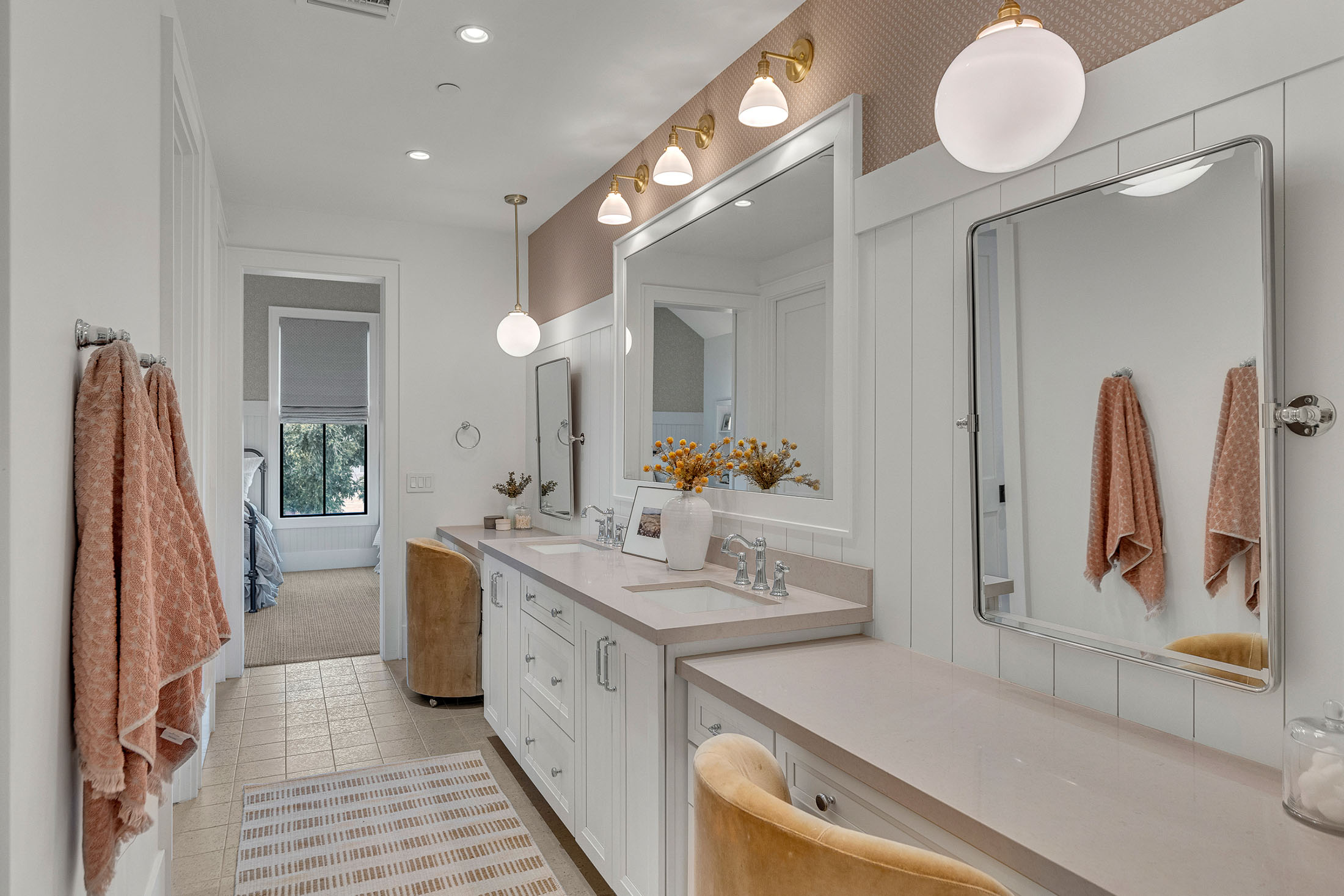 Elegant Bathroom with Dual Vanity and Gold Accents – A beautifully designed bathroom with a dual vanity, gold-accented lighting, and a large framed mirror. The soft color palette and contemporary decor elements make this a luxurious and relaxing retreat.