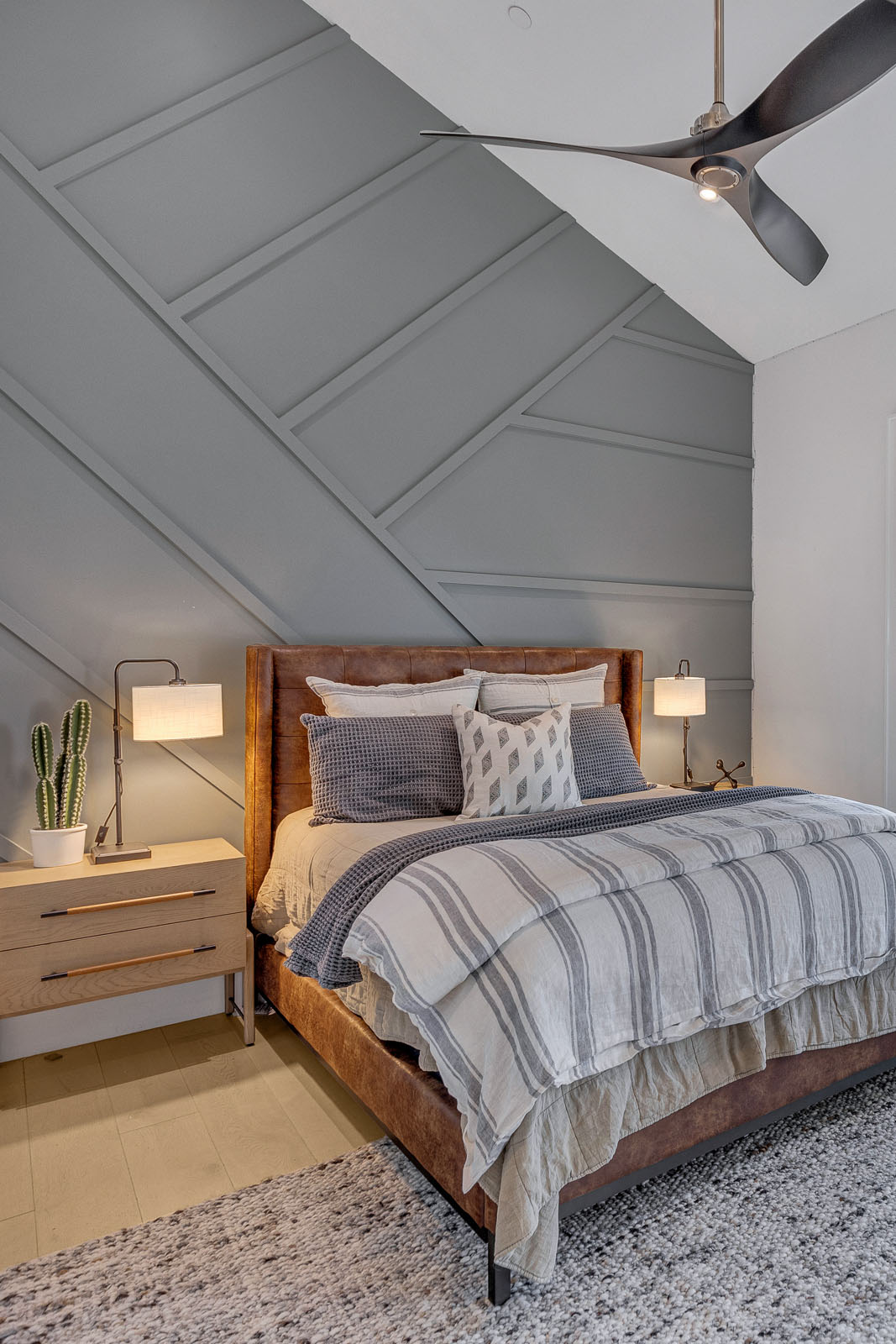 Modern Bedroom with Accent Wall and Leather Bed Frame – A stylish bedroom featuring a geometric accent wall, a leather bed frame with neutral bedding, and contemporary nightstands with sleek lighting. Perfect for modern home decor inspiration and bedroom design ideas.